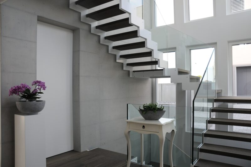 Diese moderne Treppe mit Stahlwangen und Glasgeländern gibt dem Haus den prägenden Charakter von Moderne.